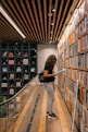 a woman reading a book in a library