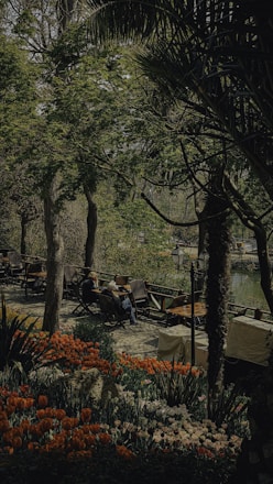 A serene outdoor setting with guests enjoying a guided cannabis tasting surrounded by lush greenery.