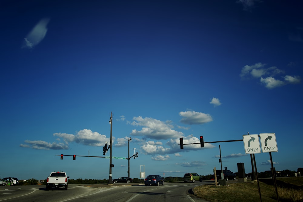 a traffic light sitting above a street filled with traffic