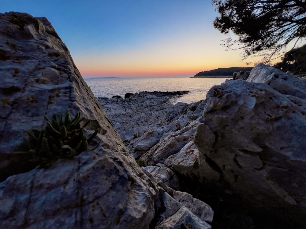 a view of the ocean from a rocky shore