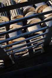 Photo of sturdy GI ladder cable trays stacked neatly in a workshop at Tevron Cable Trays.
