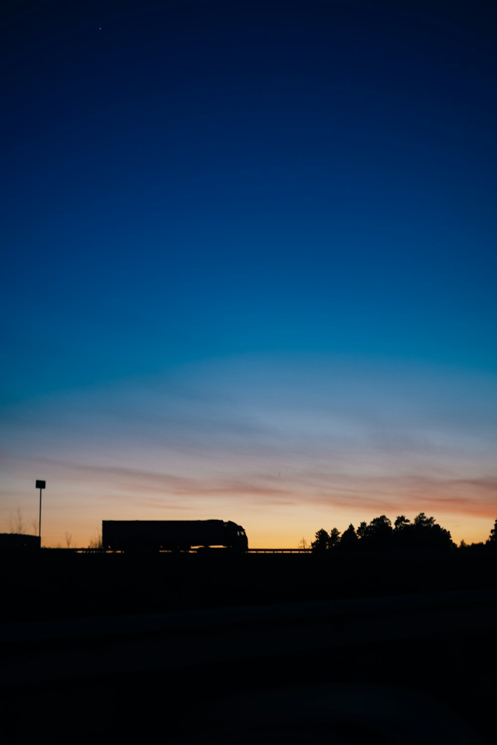 a bus driving down a road at dusk