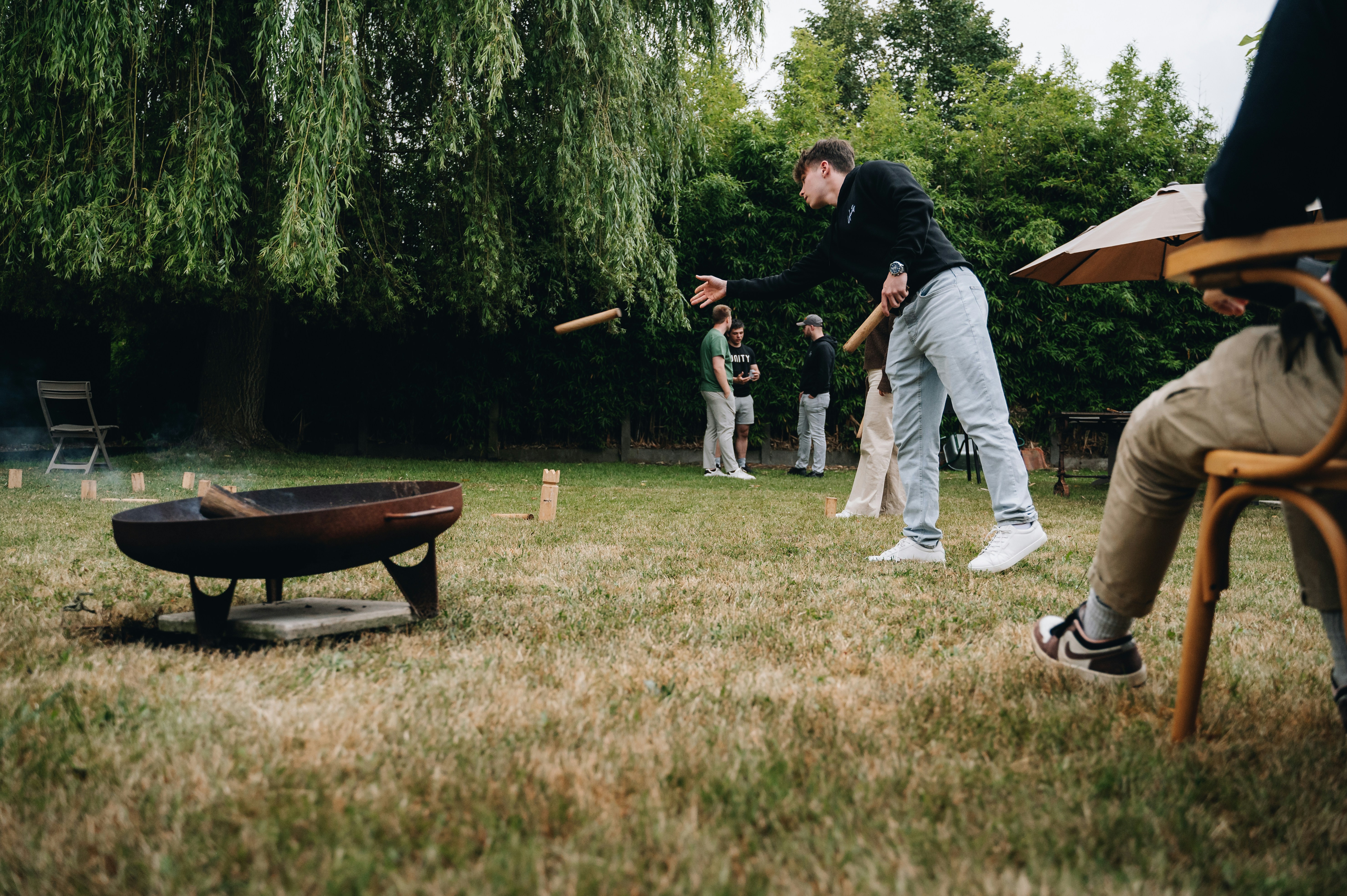a group of people standing around a fire pit