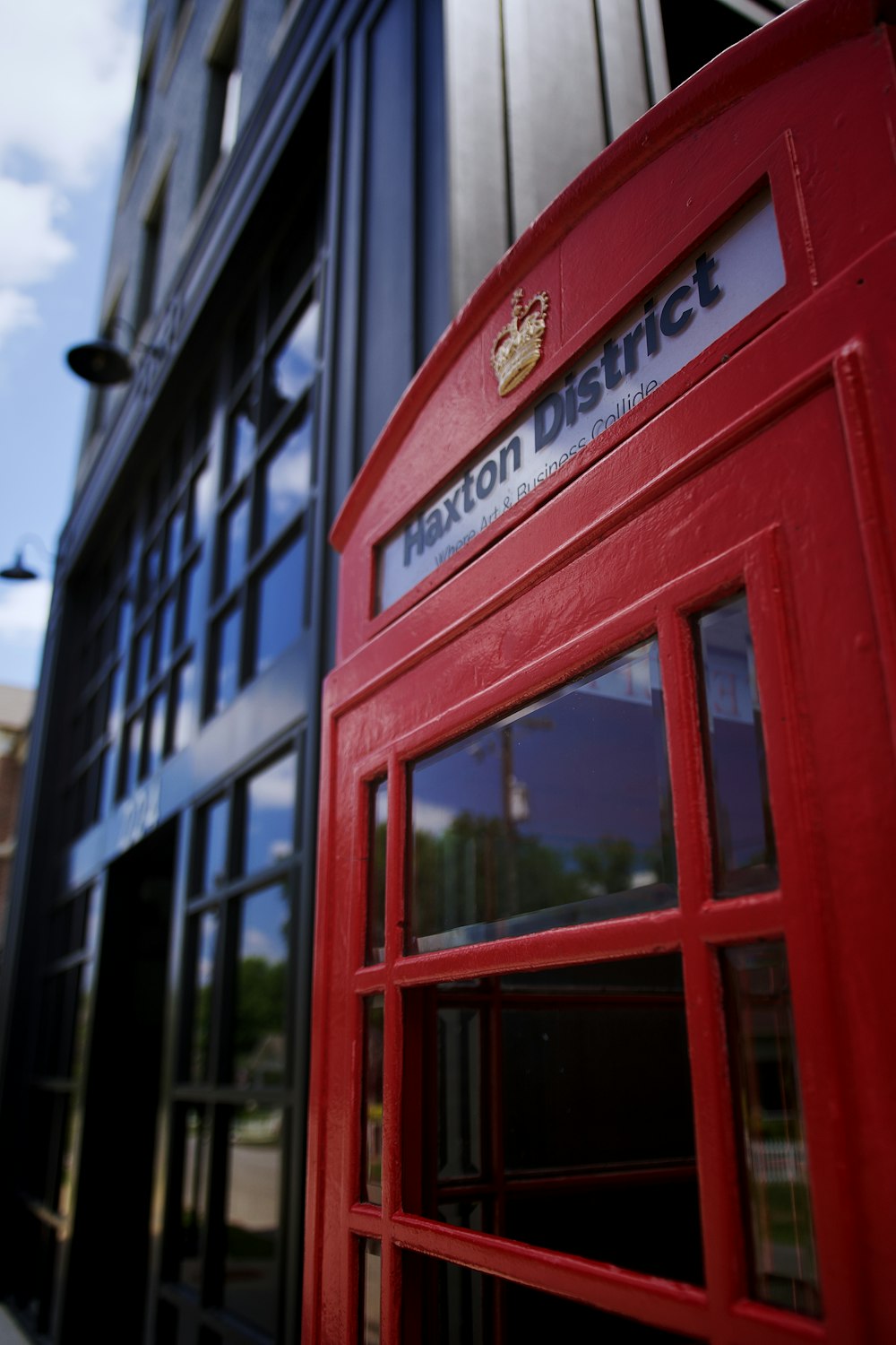 a red telephone booth in front of a building