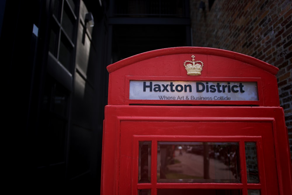 a red phone booth with a crown on top of it