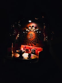 Anand chanting a powerful Shiva mantra with folded hands, surrounded by soft candlelight.