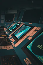 Team collaborating in a high-tech control room with digital interfaces and sleek design.