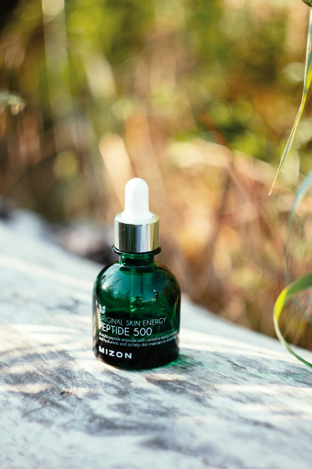 a bottle of green liquid sitting on top of a table