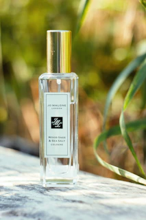 a bottle of cologne sitting on top of a table