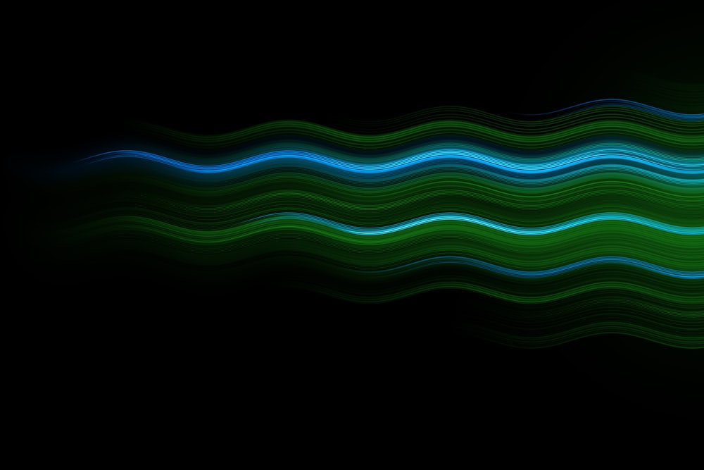 a black background with a green and blue wave