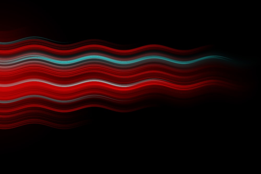 a red and blue wave on a black background
