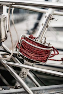 a close up of a metal structure with a red rope