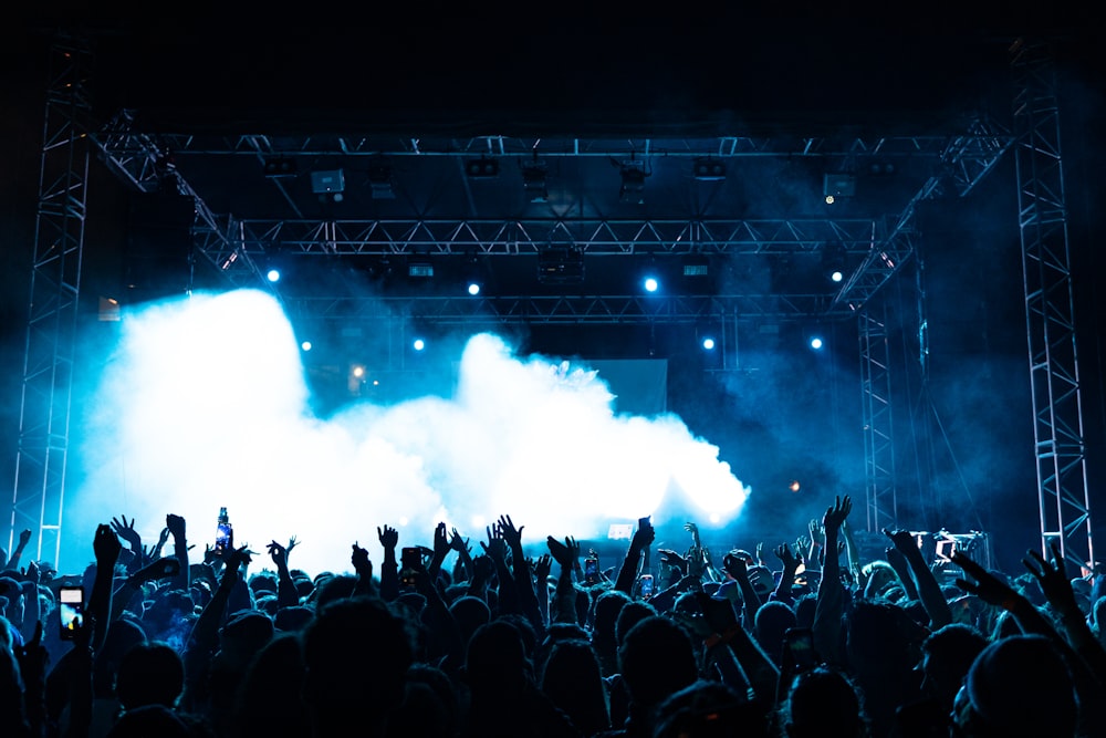 a crowd of people standing on top of a stage