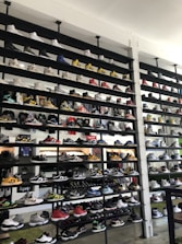 Rows of finished sneakers displayed neatly on shelves in a modern factory setting.