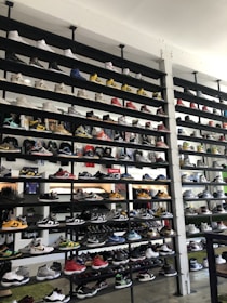 Rows of finished sneakers displayed neatly on shelves in a modern factory setting.