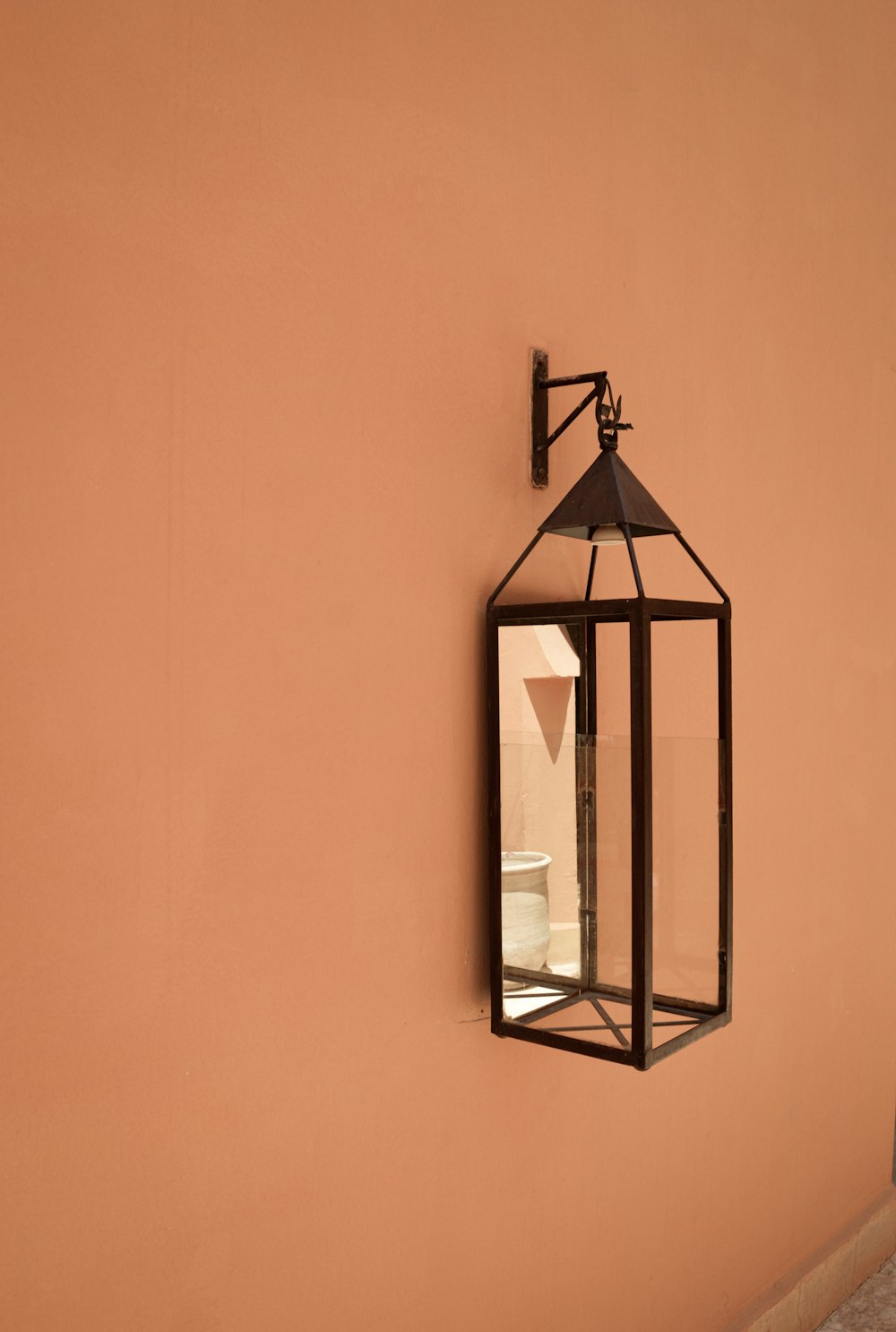 a lantern hanging on the side of a wall