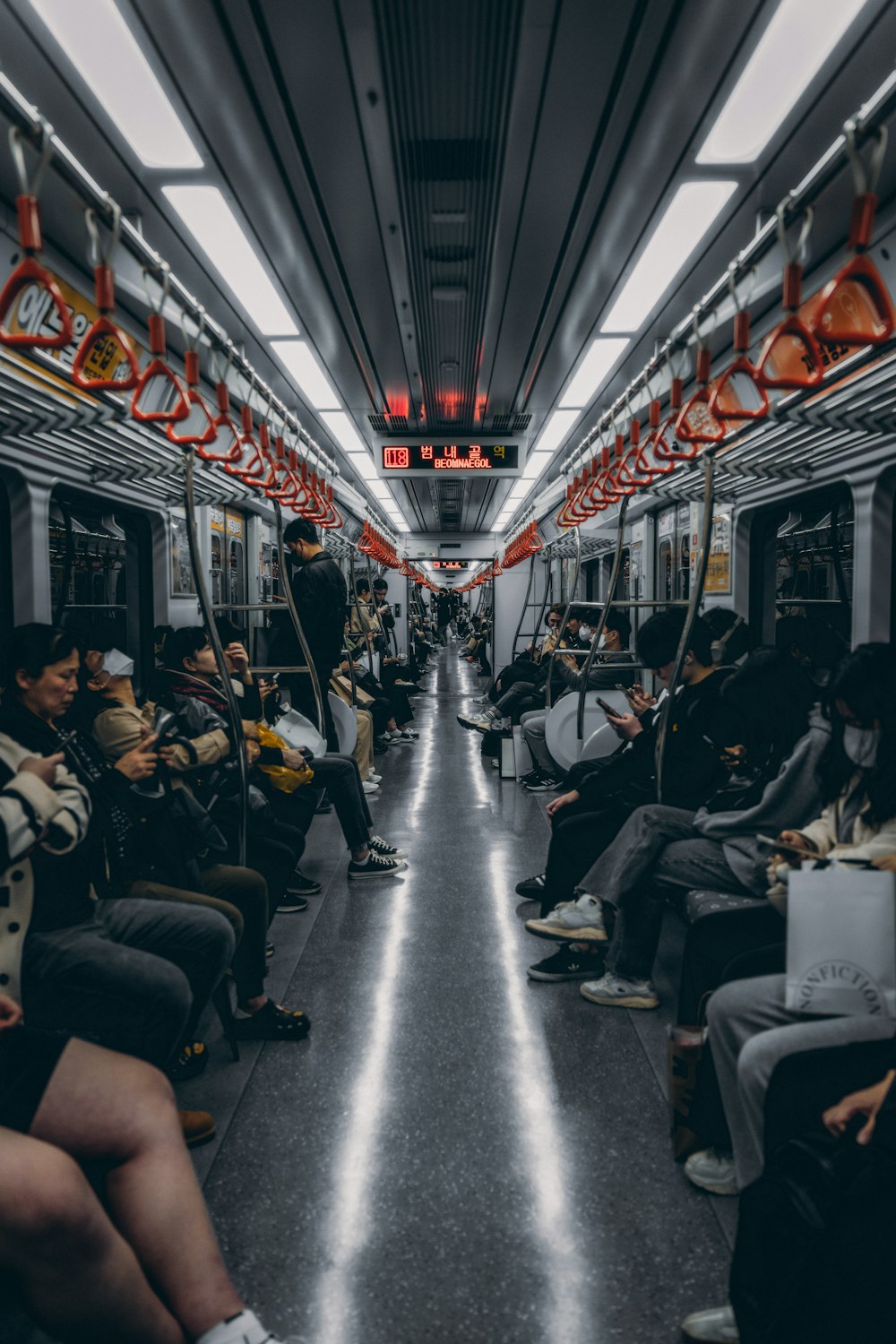 a group of people sitting on a subway train