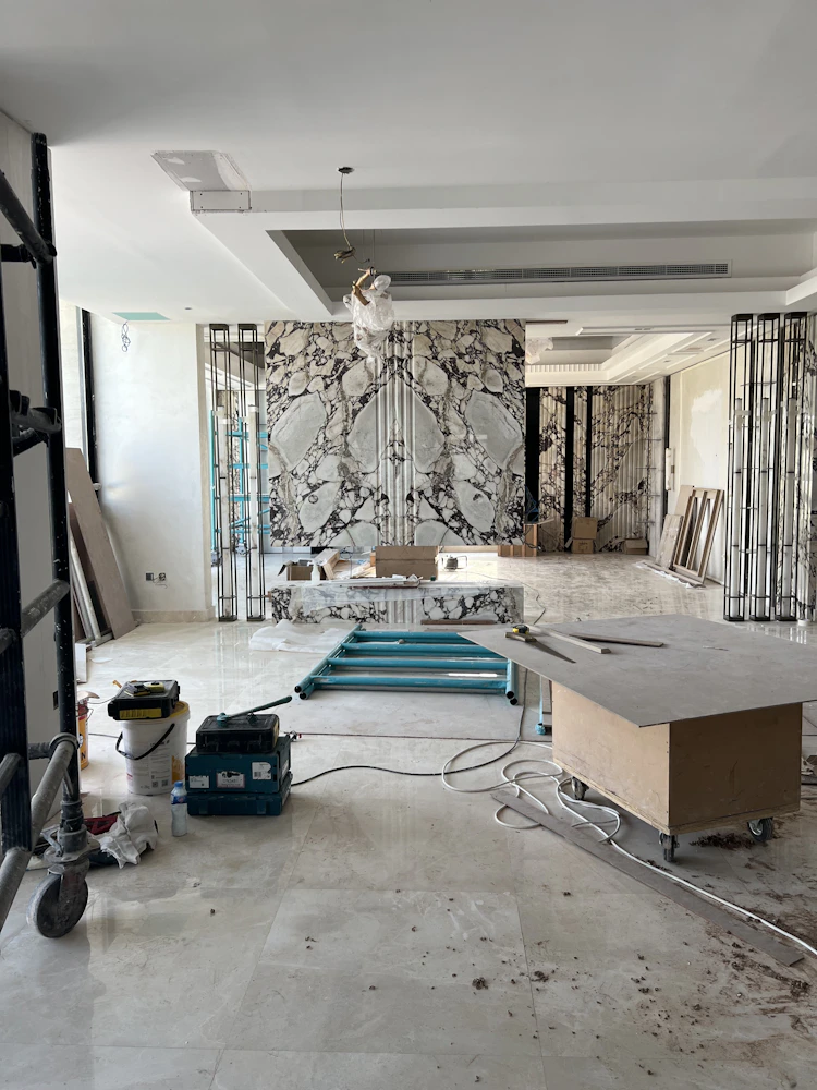 Interior fit-out in progress, marble feature wall and scaffolding