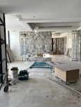 A dynamic scene showing workers installing luxury bathroom sanitary ware with tools and blueprints in a modern construction site.
