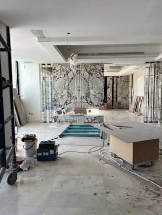 A dynamic video placeholder showing tradespeople renovating a stylish, modern home interior.