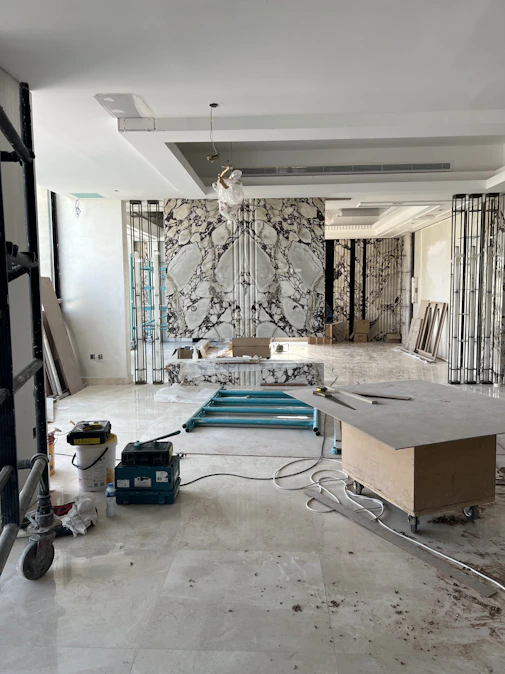 A dynamic video placeholder showing tradespeople renovating a stylish, modern home interior.
