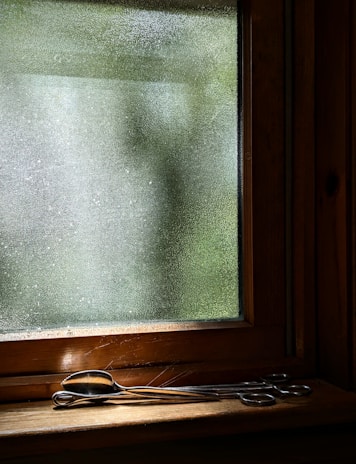 Close-up of a mouldsense test kit being gently placed on a windowsill in a bright Australian home.