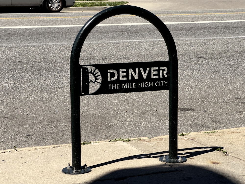 a sign on the side of the road that says denver the mile high city