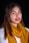 a woman wearing a yellow scarf and red lipstick