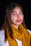 a woman wearing a yellow scarf and red lipstick