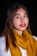 a woman wearing a yellow scarf and red lipstick