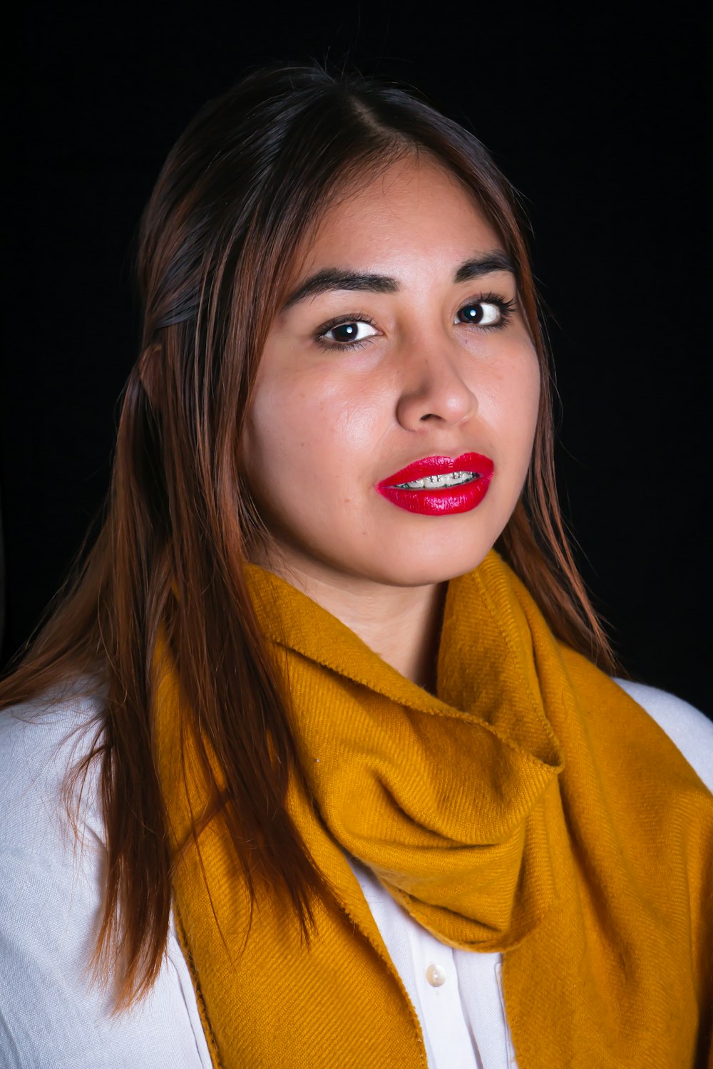 a woman wearing a yellow scarf and red lipstick