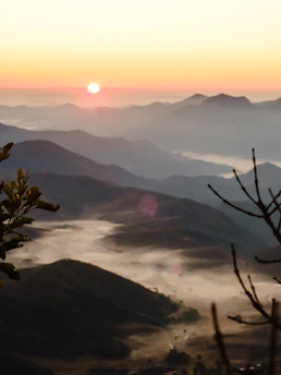 A vibrant sunrise over a peaceful mountain village, capturing the essence of early morning travel.