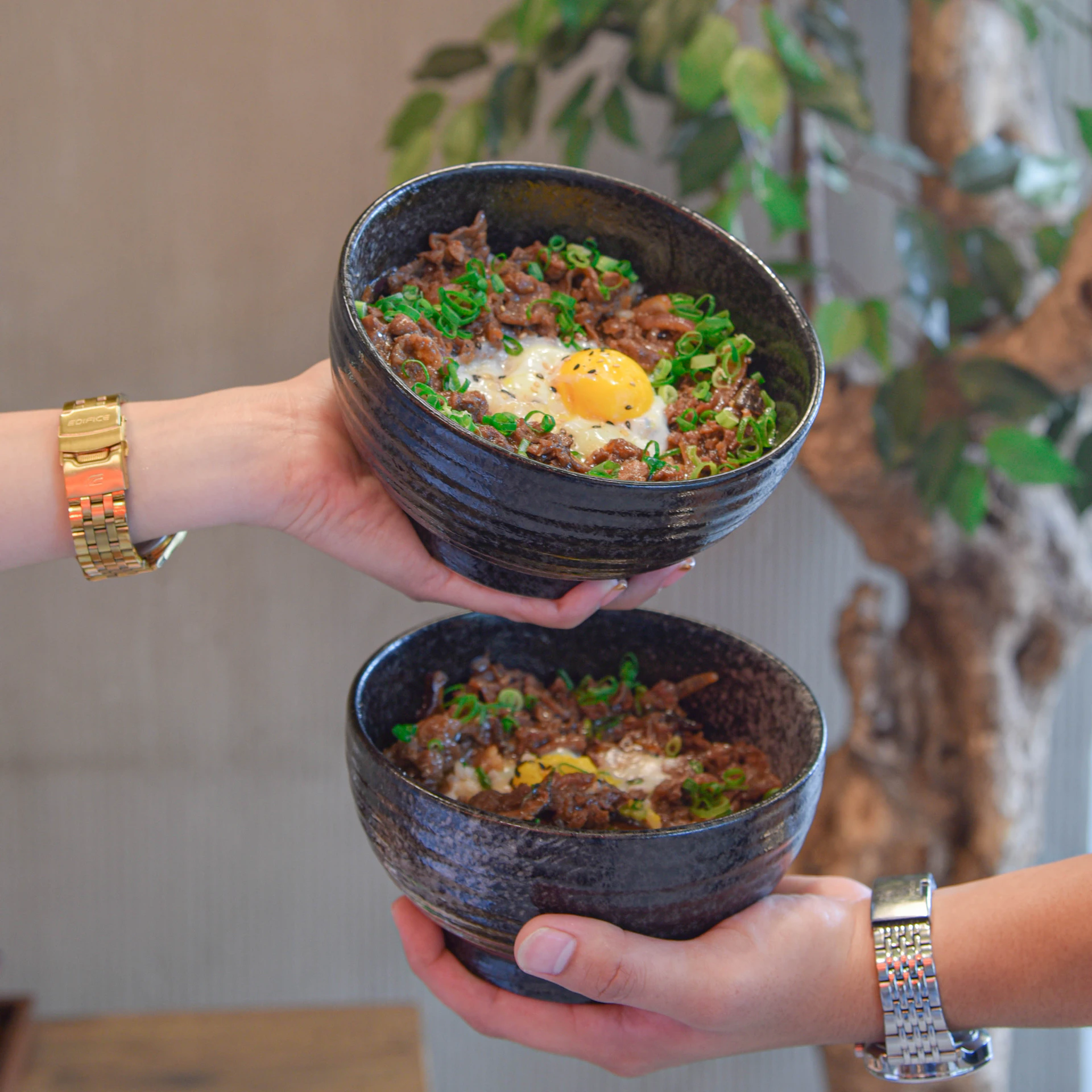 a person holding two bowls of food in their hands