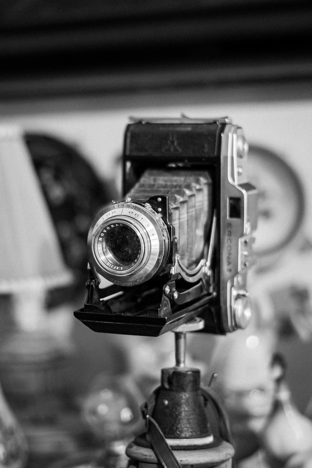 a black and white photo of a camera on a tripod