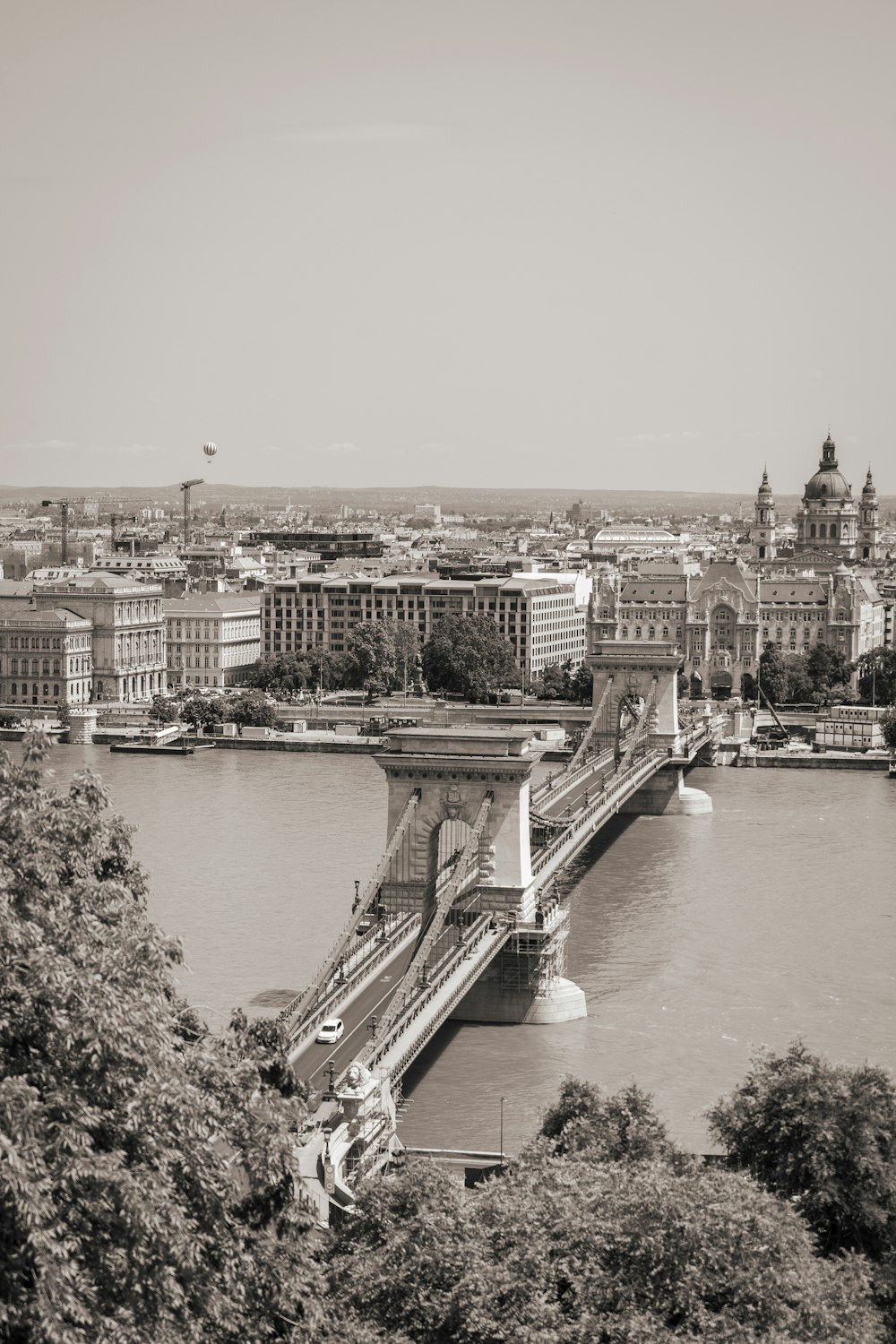 a black and white photo of a bridge over a river