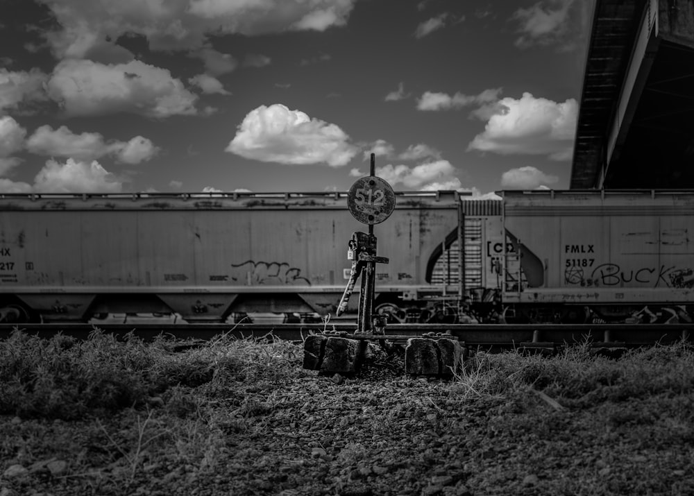 a black and white photo of a train with graffiti on it