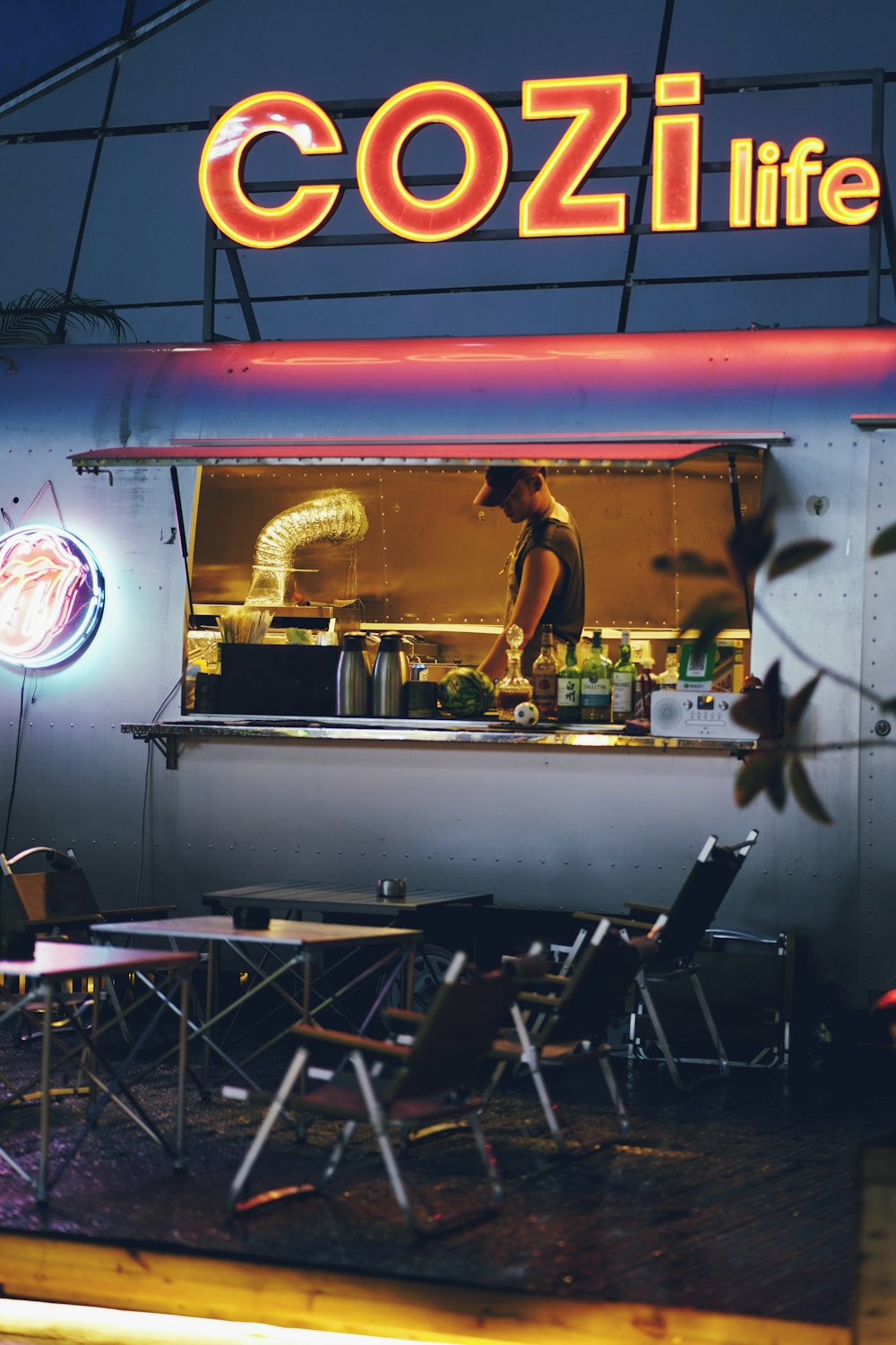 a man standing at a counter in front of a restaurant