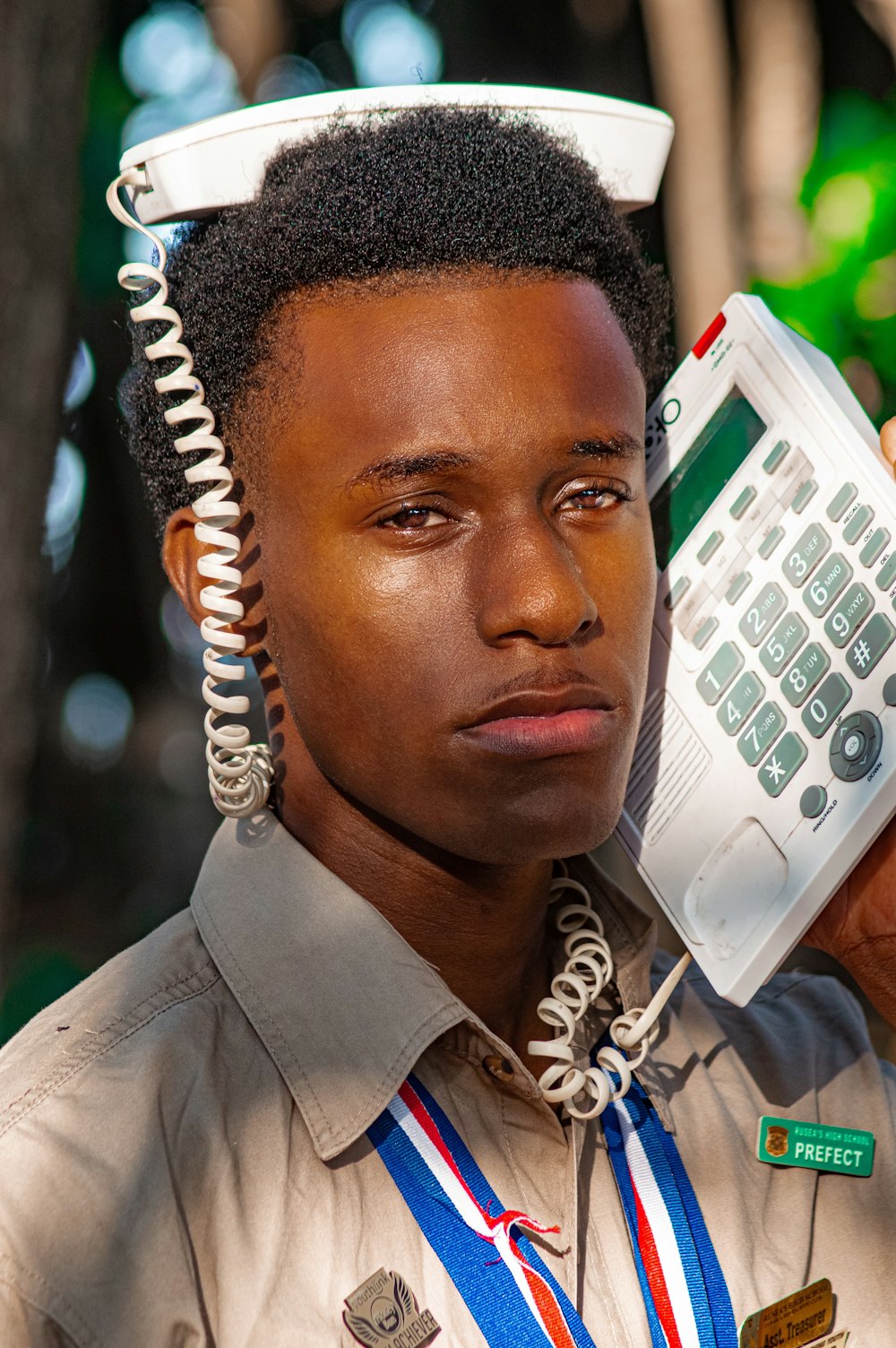 a man with a cell phone on his head