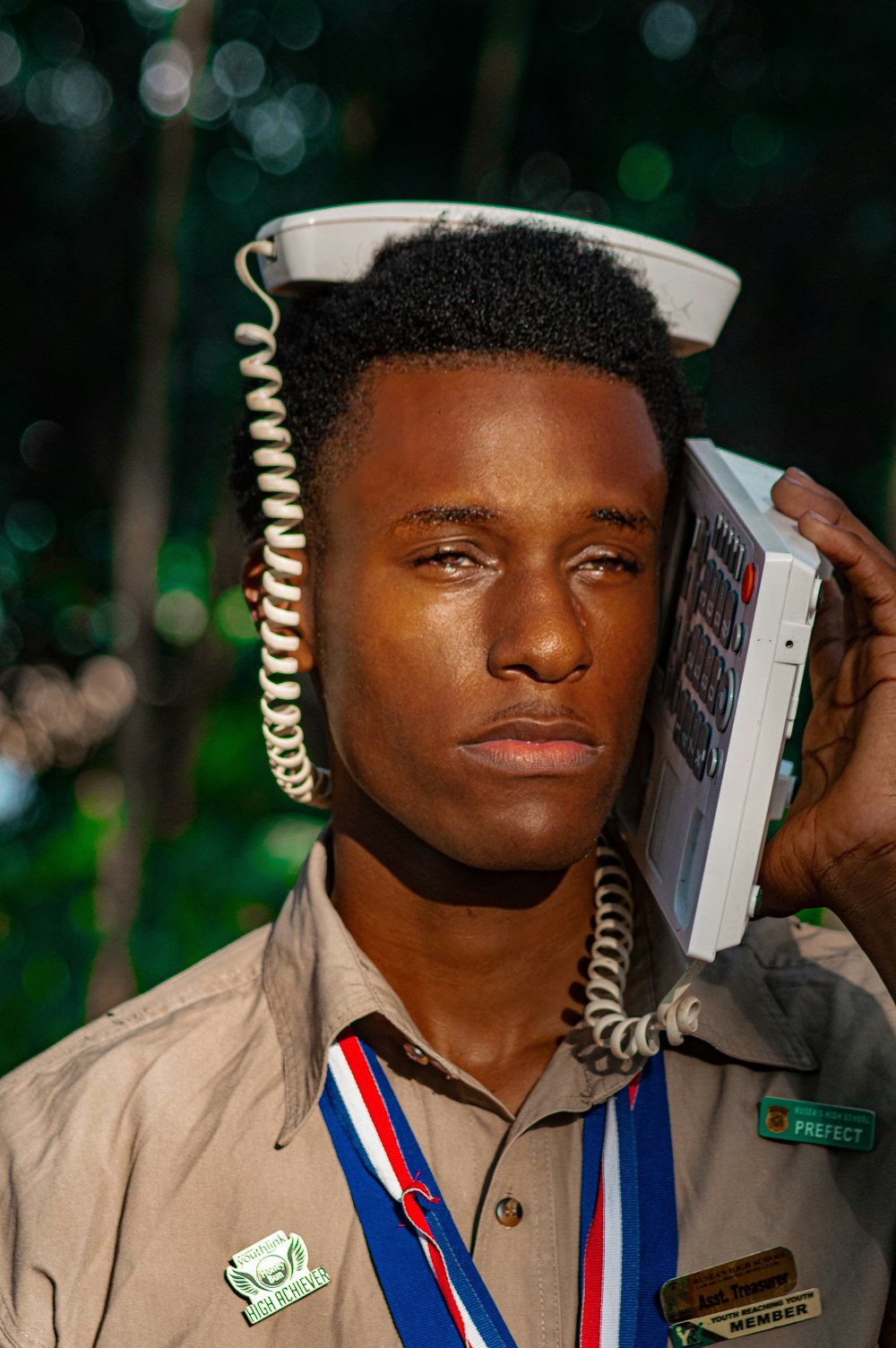 a man in a uniform holding a cell phone to his head