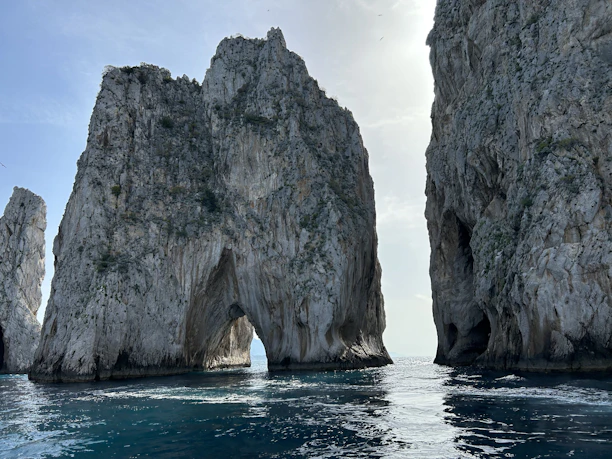 a large rock formation in the middle of a body of water