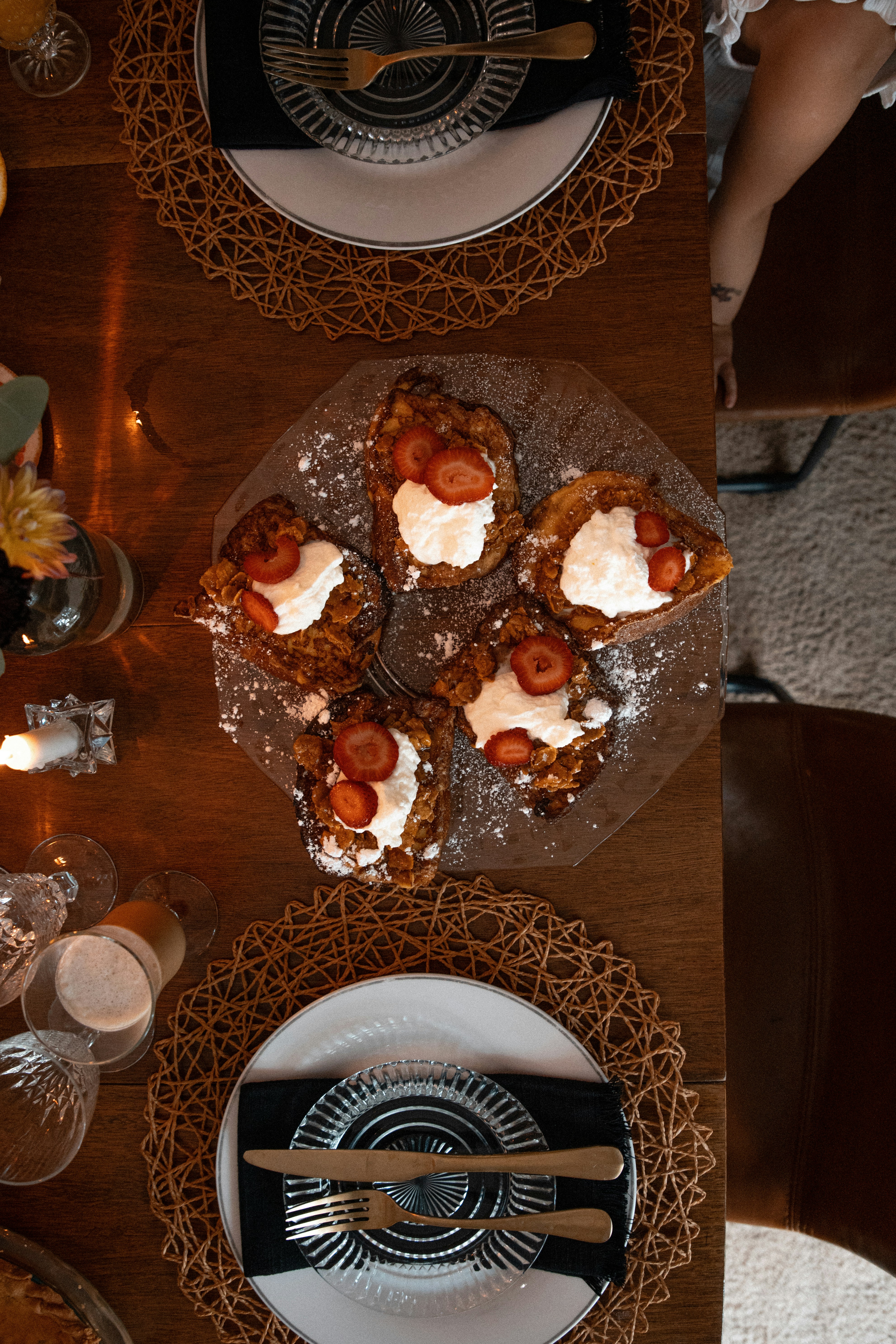 a wooden table topped with plates of food