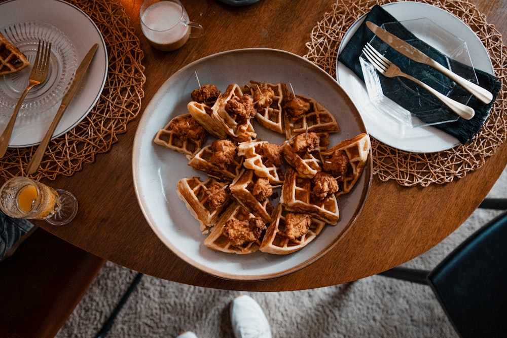 a plate of chicken and waffles on a table