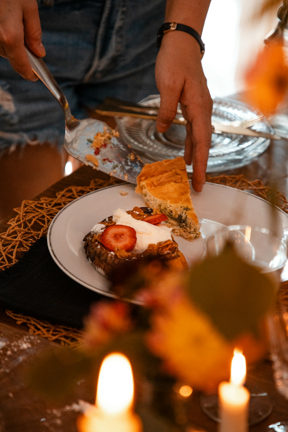 a person cutting a piece of food on a plate