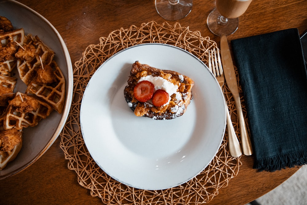 a plate of waffles and strawberries on a table