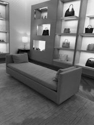 a black and white photo of a couch in a store