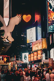 A glowing digital billboard showcasing a colorful social media campaign against a dark cityscape.