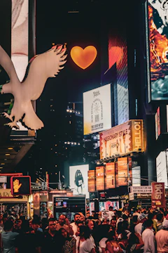 A glowing digital billboard showcasing a colorful social media campaign against a dark cityscape.