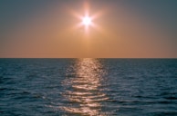 A peaceful sunset over the Kouilou region, casting golden light on the community.