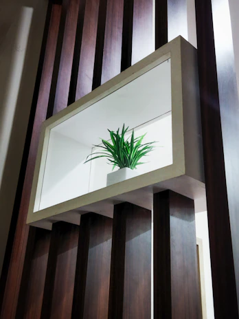 A modern, minimalist 3D-printed home decoration piece placed on a wooden shelf with soft natural light.