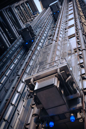 Professional installation team fitting a new elevator system in a commercial building.